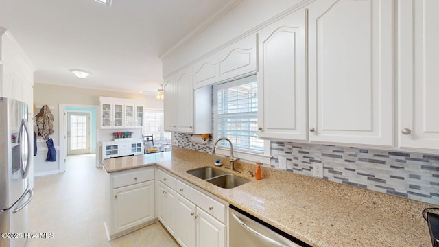 kitchen featuring crown molding, stainless steel appliances, sink, and white cabinets