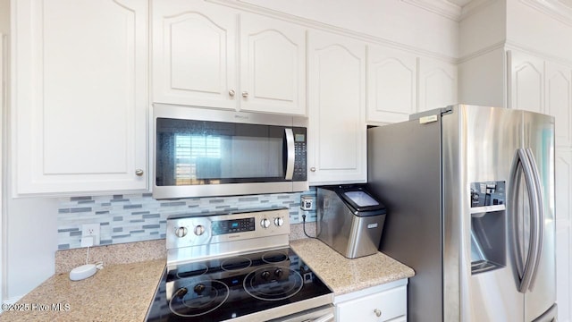 kitchen featuring tasteful backsplash, light stone countertops, appliances with stainless steel finishes, and white cabinets