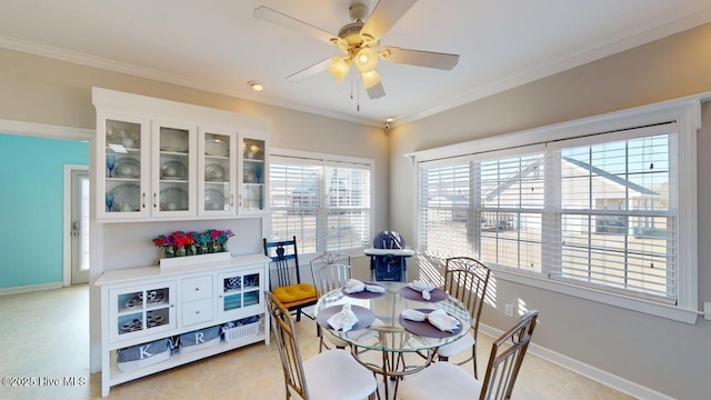 dining area featuring ceiling fan and ornamental molding