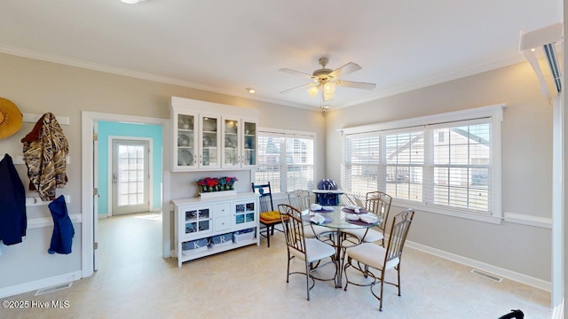 dining space with ornamental molding and ceiling fan