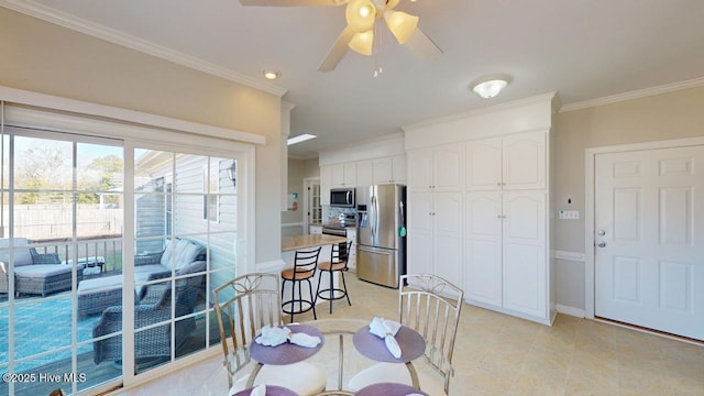 dining area with ornamental molding and ceiling fan