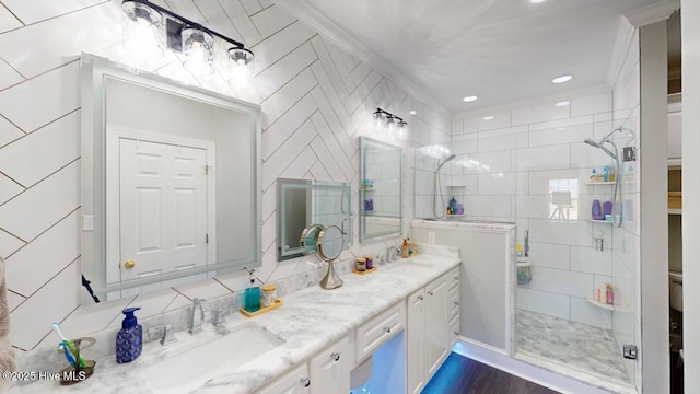 bathroom with an enclosed shower, vanity, and tile walls