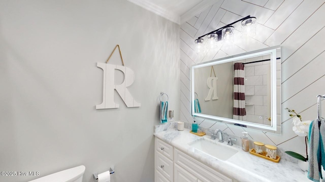 bathroom with tasteful backsplash, vanity, tile walls, and toilet