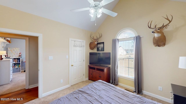 bedroom with multiple windows, light carpet, high vaulted ceiling, and ceiling fan