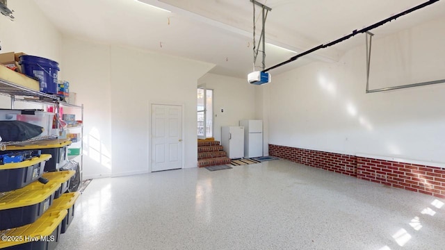 garage featuring a garage door opener and white refrigerator