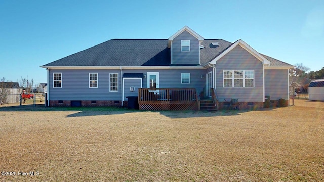 back of property featuring a wooden deck and a lawn