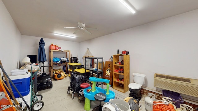 game room featuring a wall mounted air conditioner and ceiling fan