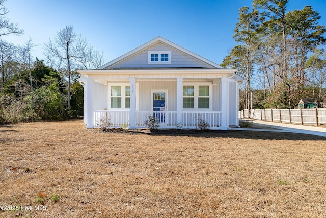 neoclassical home featuring a porch and a front yard