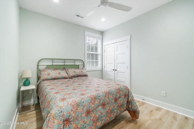 bedroom featuring light hardwood / wood-style flooring, a closet, and ceiling fan