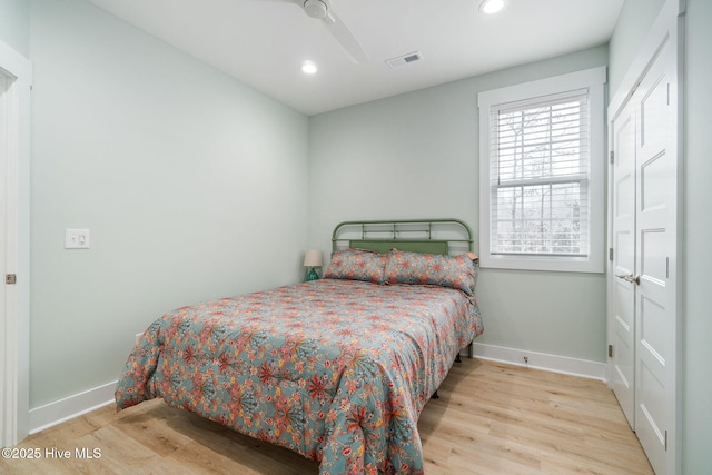 bedroom with ceiling fan and light hardwood / wood-style floors