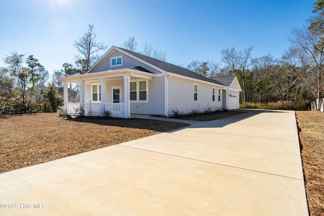 view of front of property with a porch and a garage