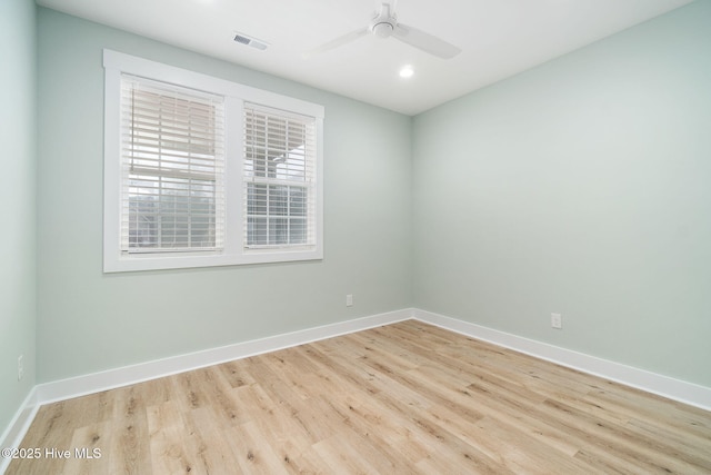 spare room with light hardwood / wood-style floors and ceiling fan