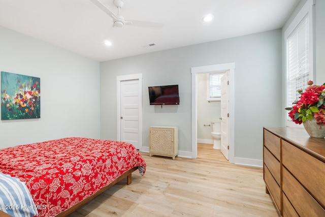 bedroom featuring ceiling fan, ensuite bathroom, and light hardwood / wood-style floors