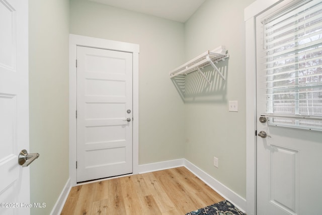 laundry room with light hardwood / wood-style flooring and a wealth of natural light