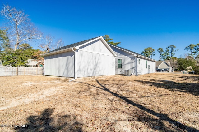 view of side of property with a yard and central AC unit