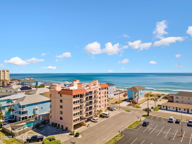 drone / aerial view with a water view and a view of the beach