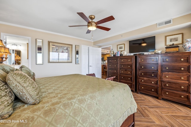 bedroom with ceiling fan, crown molding, and light parquet floors