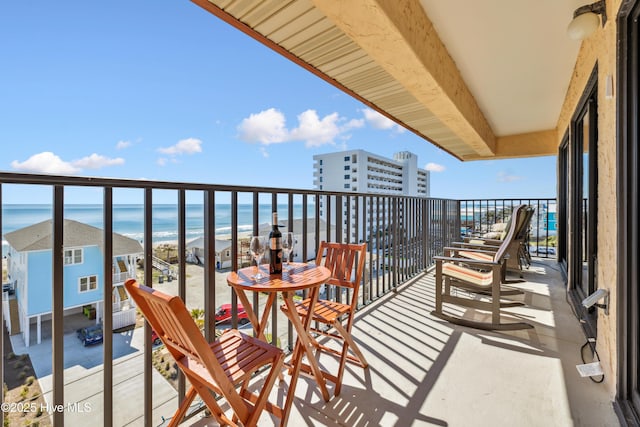 balcony with a view of the beach and a water view