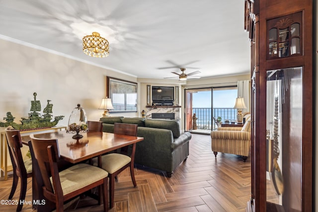 living room with a wealth of natural light, parquet flooring, and ornamental molding