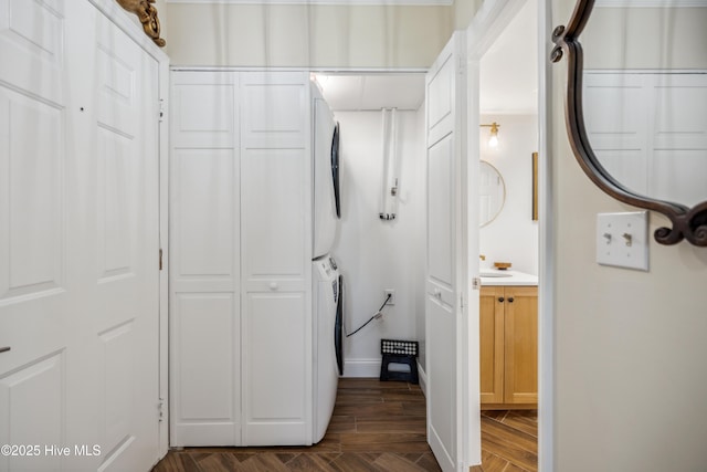 corridor featuring dark hardwood / wood-style flooring and stacked washer / drying machine