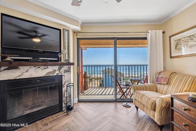 living room with a water view, ceiling fan, and parquet floors