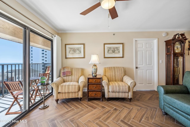 sitting room featuring crown molding, parquet flooring, and ceiling fan