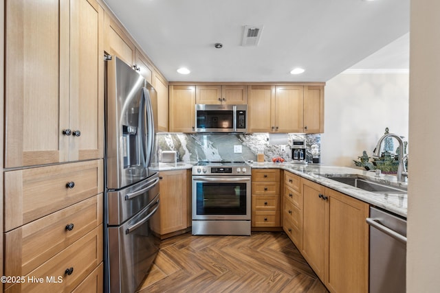 kitchen featuring sink, backsplash, stainless steel appliances, dark parquet floors, and light stone countertops