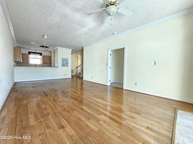 unfurnished living room with ornamental molding, a textured ceiling, ceiling fan, and light wood-type flooring