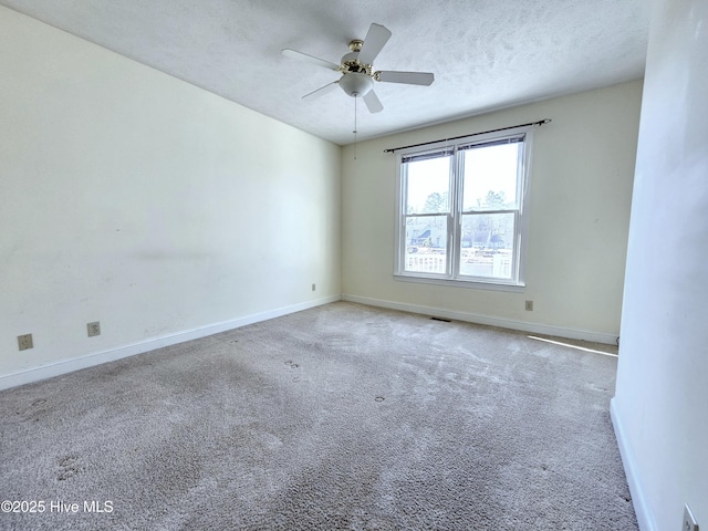 spare room featuring ceiling fan, a textured ceiling, and carpet flooring