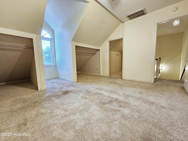 bonus room with vaulted ceiling and carpet floors