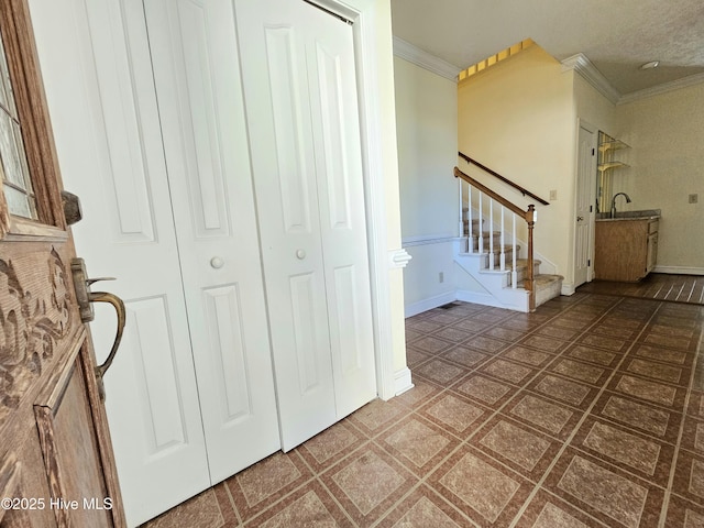 foyer with sink and ornamental molding