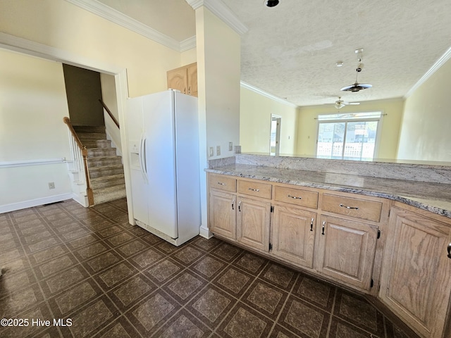 kitchen with light brown cabinetry, white refrigerator with ice dispenser, ornamental molding, and a textured ceiling