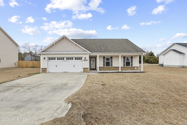 view of front of property featuring a garage, central AC, a porch, and a front yard