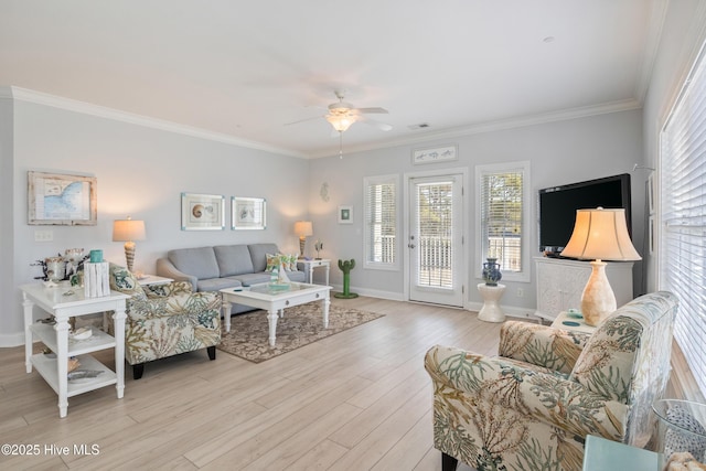 living room featuring ornamental molding, ceiling fan, and light hardwood / wood-style flooring