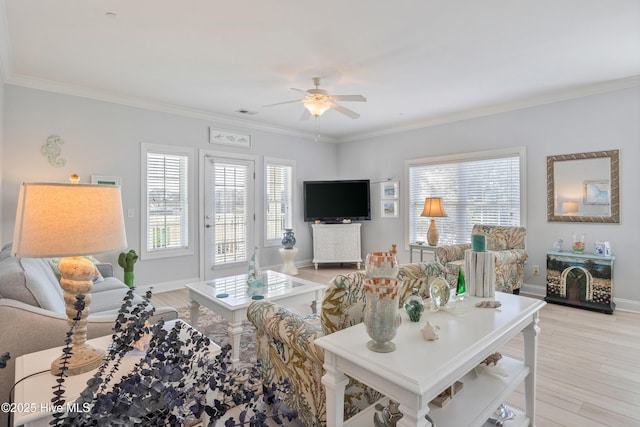 living room with ceiling fan, ornamental molding, and light wood-type flooring