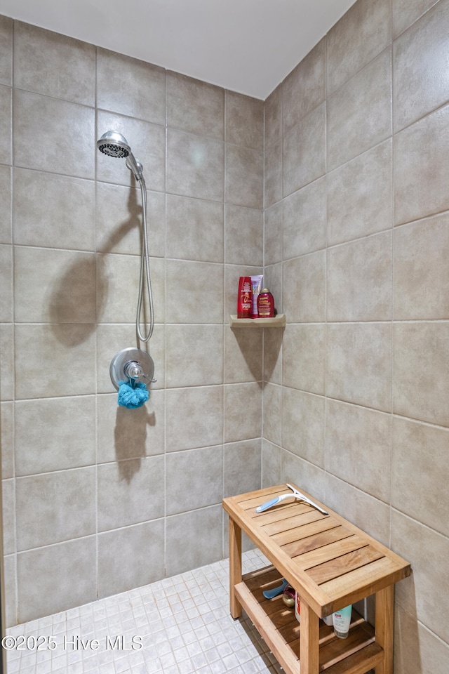 bathroom with tiled shower