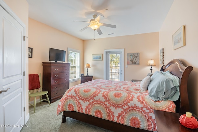 bedroom with ceiling fan, access to exterior, and light carpet