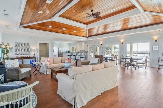 living room with wood ceiling, ceiling fan, hardwood / wood-style floors, ornamental molding, and a raised ceiling