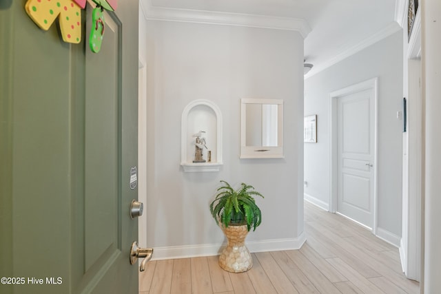 foyer entrance featuring ornamental molding and light hardwood / wood-style floors