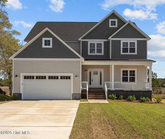 craftsman-style house with driveway, board and batten siding, an attached garage, a front yard, and covered porch