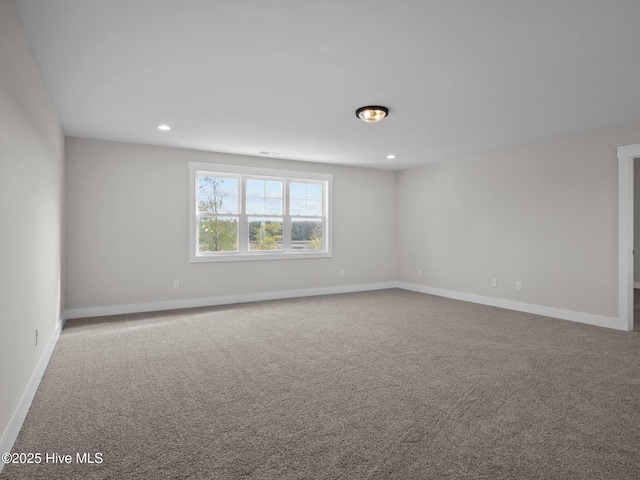 empty room featuring carpet flooring, baseboards, and recessed lighting