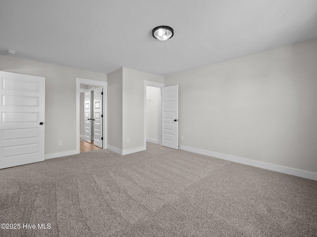 unfurnished bedroom with baseboards and carpet