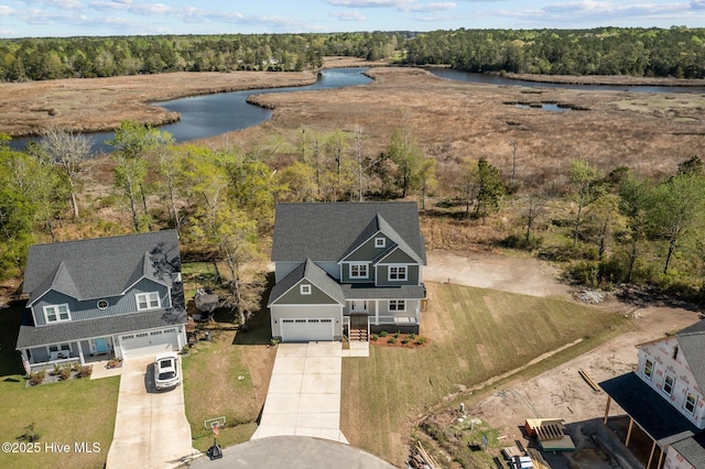 aerial view with a wooded view and a water view