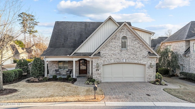 view of front of property featuring a garage and a porch