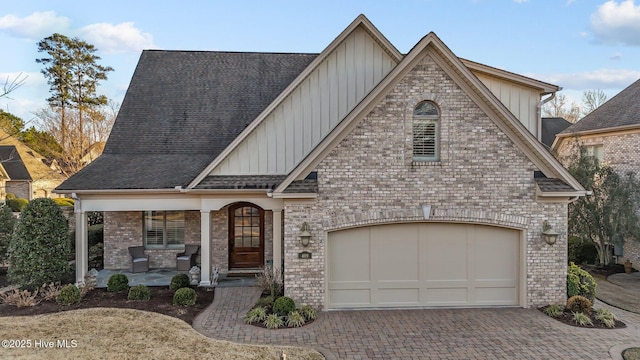 view of front of home with a porch and a garage