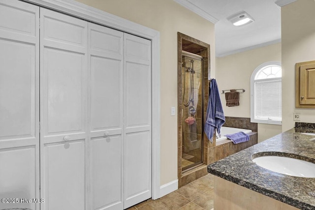 bathroom featuring a shower with door, crown molding, tile patterned floors, and vanity