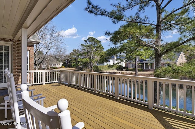 wooden deck featuring a water view