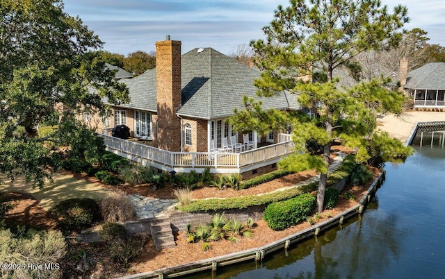 rear view of house featuring a water view