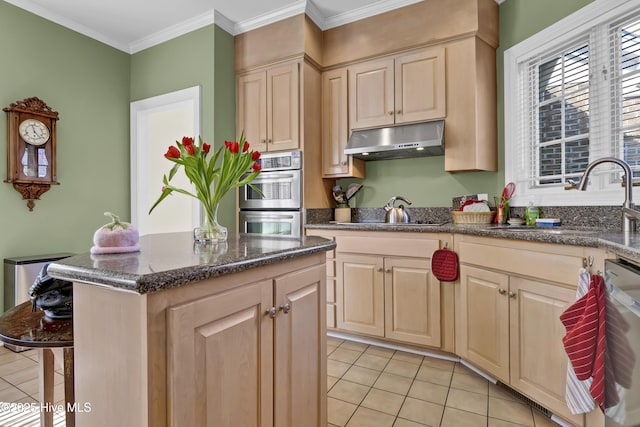 kitchen with sink, crown molding, a center island, light tile patterned floors, and appliances with stainless steel finishes