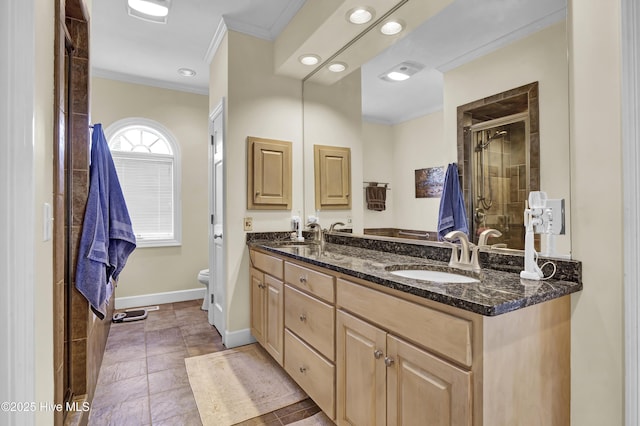 bathroom featuring vanity, crown molding, toilet, and walk in shower